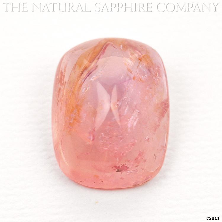 C2011 is a stunning 7.60 carat padparadscha sugarloaf cabochon sapphire