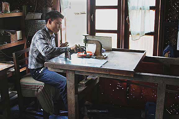 Gem cutter in action, cutting rough gemstones into faceted gemstones