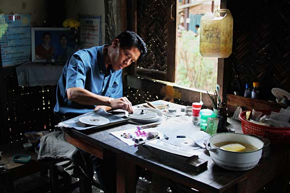 gem cutter working on gemstone after being cut