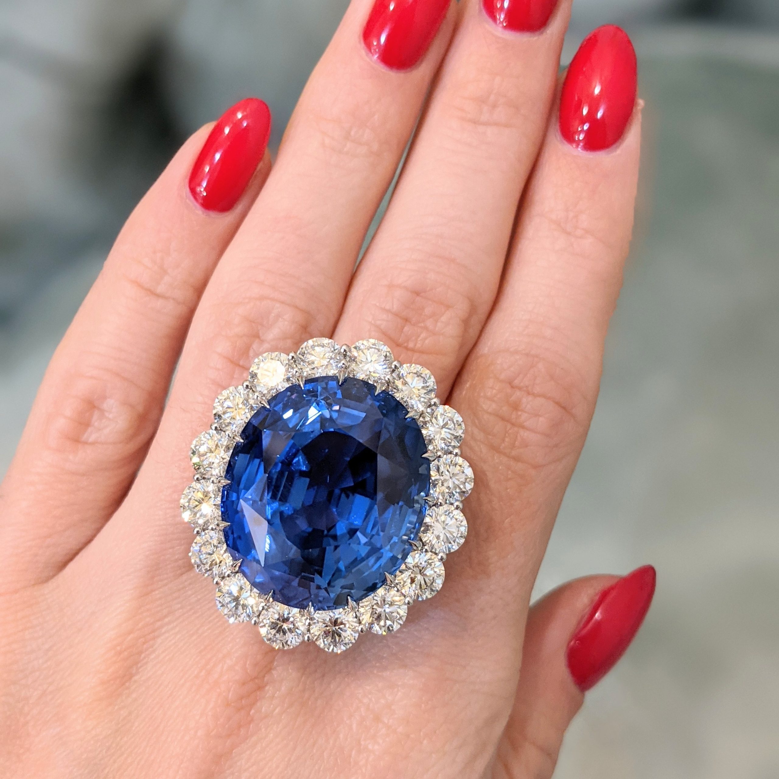 The 69.35-carat Ceylon sapphire halo ring J2565 shown on the hand
